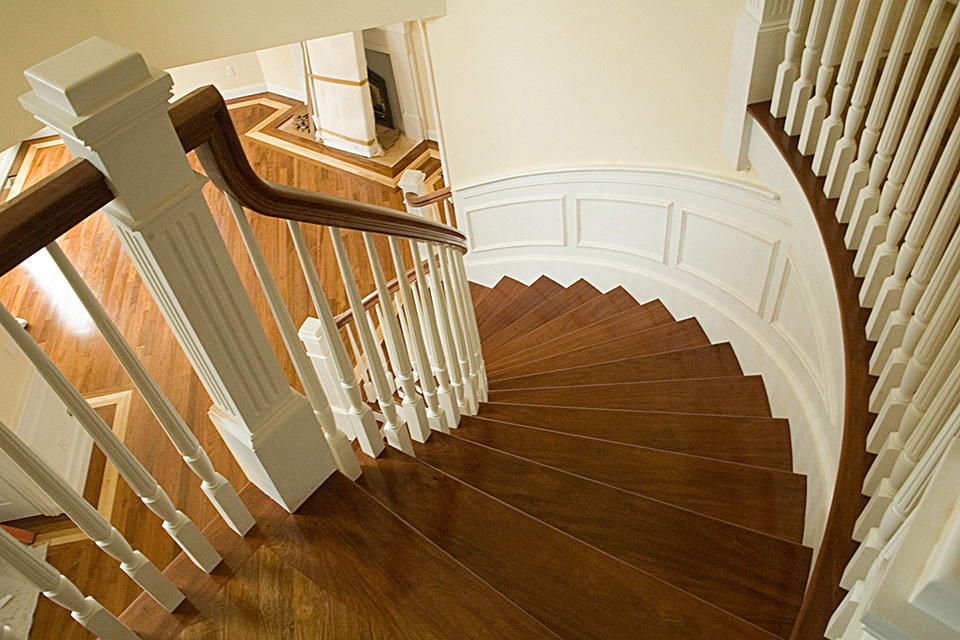 view of curved staircase from second floor landing